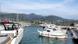 A marina with boats docked, a mountainous backdrop, and a clear sky. - Casa Azzurra - One Bedroom Apartment, Sleeps 4 (Arenzano)