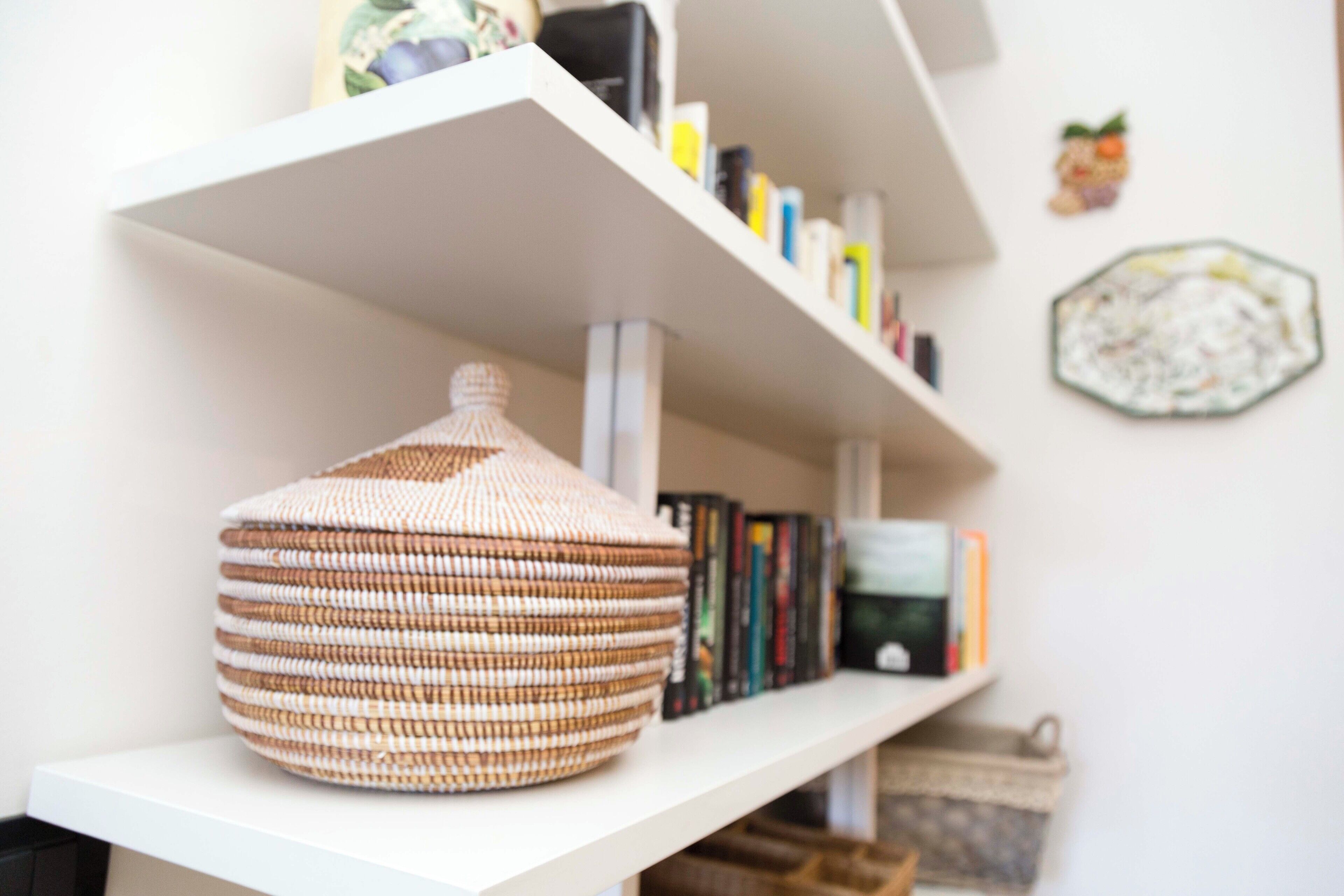 A bookshelf with books and decorative items.