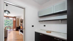 A modern kitchen with dark cabinetry, a white countertop, and a built-in oven. - Casa Luxury Golf - One Bedroom Apartment, Sleeps 3 (Arenzano)