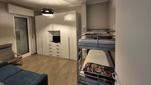 A compact bedroom with a bunk bed, a desk, and a chair. - Casa Mimose - Two Bedroom Apartment, Sleeps 5 (Cogoleto)