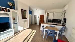 A modern apartment with a living room, dining area, and kitchen. - Casa Mimose - Two Bedroom Apartment, Sleeps 5 (Cogoleto)