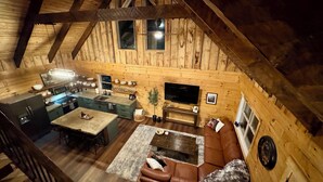 A loft-style room with a kitchen, dining area, and seating area.