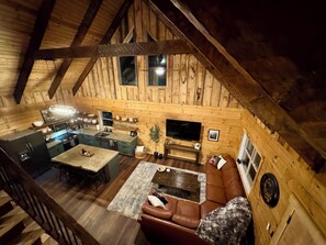 A loft-style room with a kitchen, dining area, and seating area.