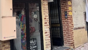 A boutique hotel with a brick facade, a balcony with a metal railing, and a sign indicating it is a boutique hotel. - Balatlifesuites (İstanbul)
