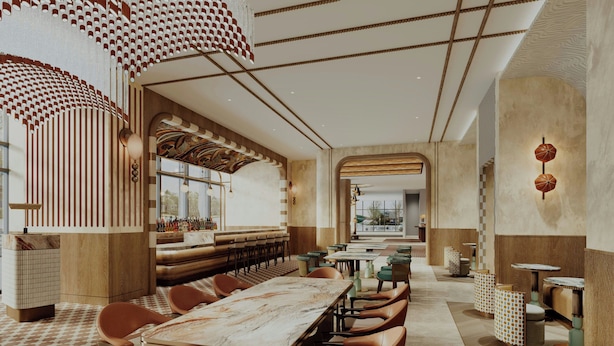 Un restaurant moderne doté d’une longue table conviviale, de banquettes et d’un plafond orné de motifs.
