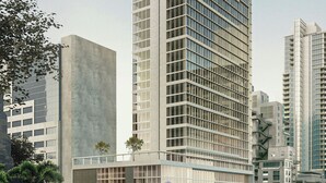 Een hoog gebouw met een modern ontwerp, gekenmerkt door een raster van ramen en een plat dak.