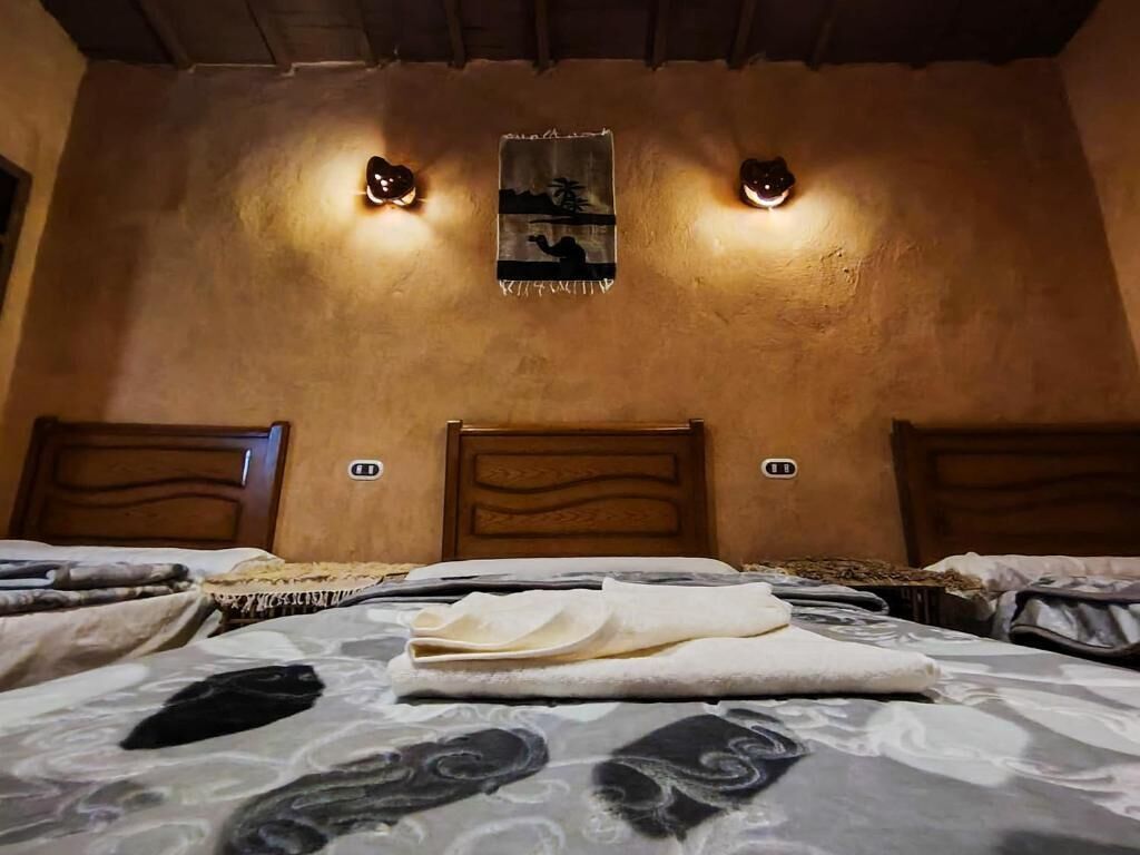 Ein Schlafzimmer mit einem Bett, zwei Wandleuchten und einem Bild an der Wand.