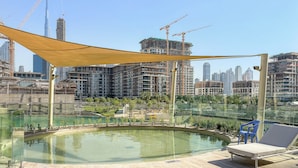 A rooftop pool area with a view of a city skyline and construction cranes. - Silkhaus Myrtle 1 (Dubai)