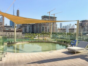 A rooftop pool area with a view of a city skyline and construction cranes. - Silkhaus Myrtle 1 (Dubai)