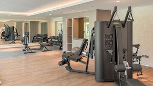 A gym with various exercise equipment, including a cable machine and weight benches. - Silkhaus Myrtle 1 (Dubai)