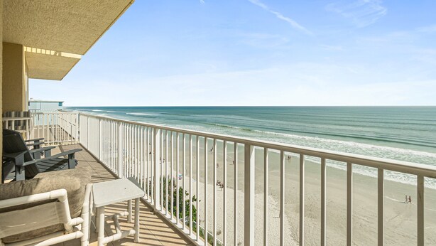 A balcony with a view of the beach, outdoor furniture, and a railing. - NSB Malibu Condos 804-malibu 804 (New Smyrna Beach)