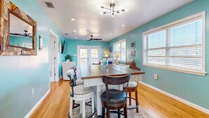 A spacious kitchen with a large island, wooden flooring, and a ceiling fan. - Daytona Beach Retreat (Daytona Beach)