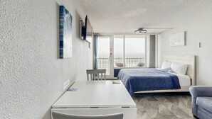 A bedroom with a bed, a desk, and a chair. - Daytona Pirates Cove 3270-salt Air Cove (Daytona Beach Shores)