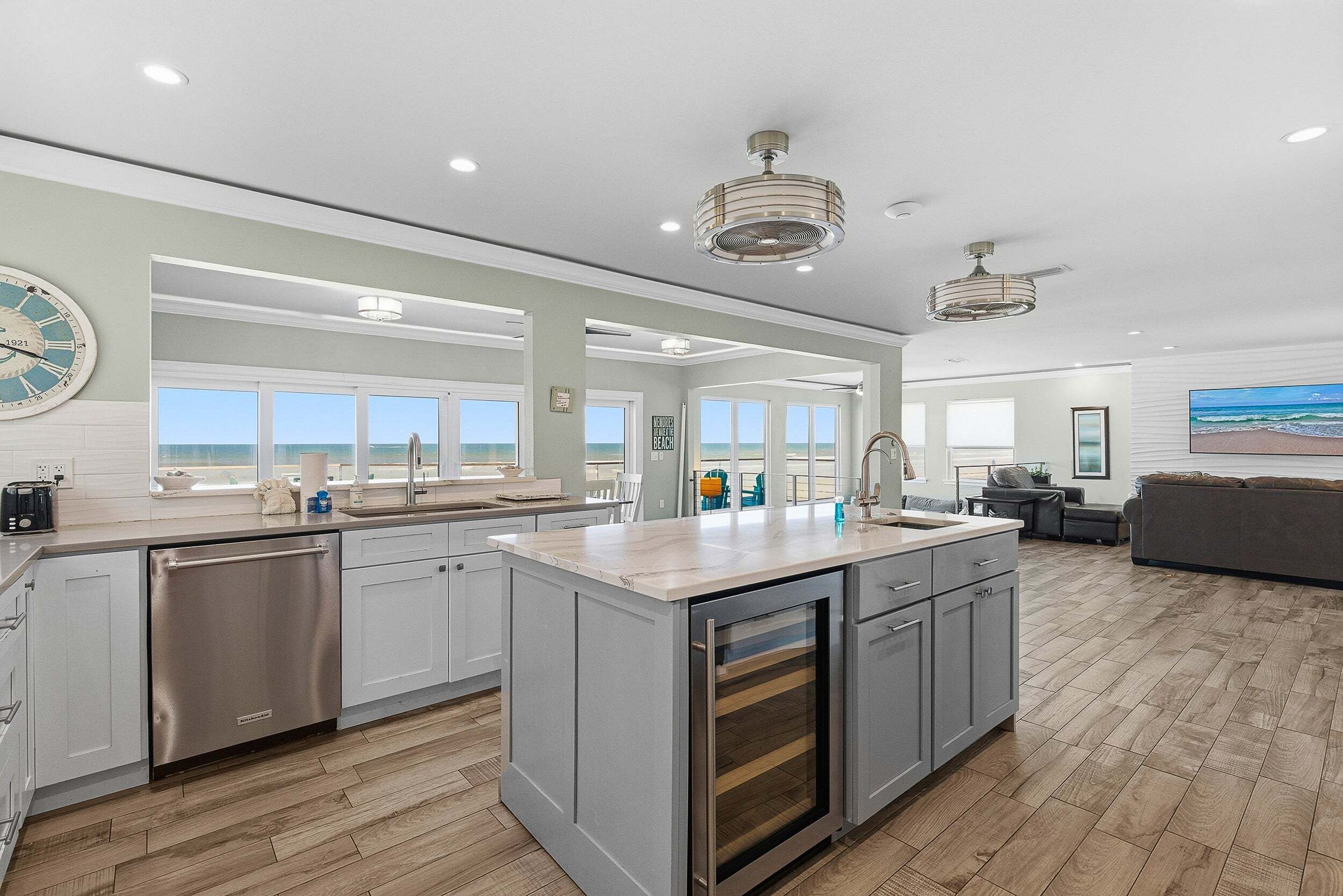 A spacious kitchen with a large island, modern appliances, and a view to the outside.