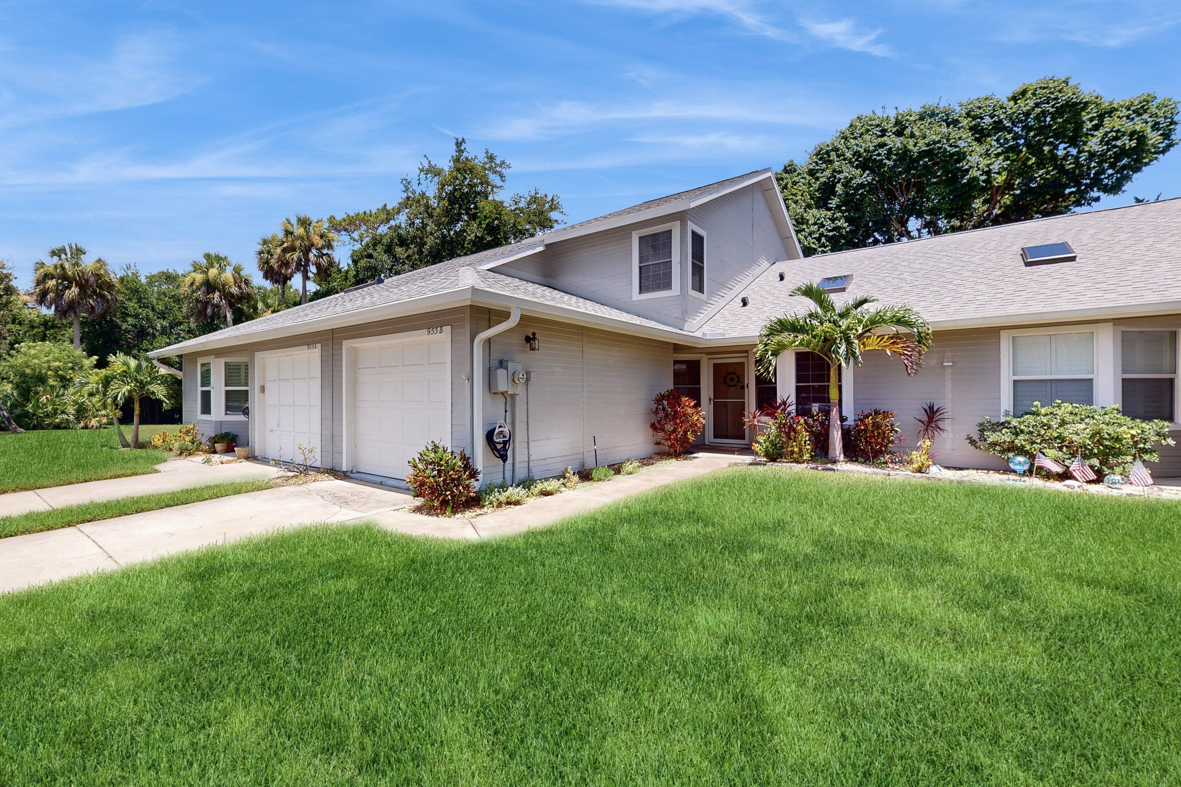 A single-story house with a garage, a covered front porch, and a well-maintained lawn.