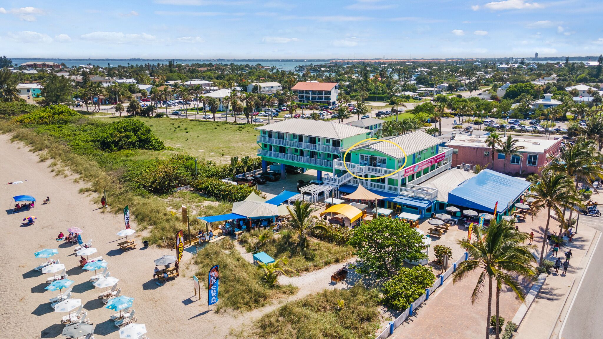 A coastal hotel with a beachfront view, multiple dining areas, and a pool.