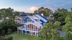 A two-story house with a covered porch and a small deck. - Beach Access, Hot Tub, Ping Pong Table, Bikes! (Tybee Island)