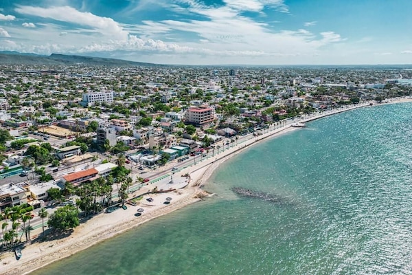 Beach nearby, white sand, beach umbrellas, beach towels