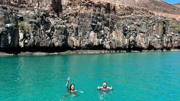 Beach nearby, white sand, beach umbrellas, beach towels