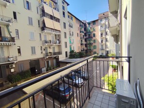 A residential building with balconies, a parking area, and a clear sky. - BIG Smart Goldoni [Duomo-M4 Lin Airport] (Milan)
