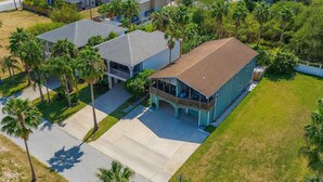 An aerial view of a residential area with houses, palm trees, and a well-maintained lawn. - Unique 2 in 1  * BayViews * Pool (South Padre Island)