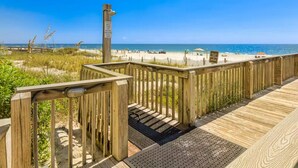A wooden boardwalk leading to a beach with a clear view of the ocean. - Bluewater 103 | Beach Front (Orange Beach)