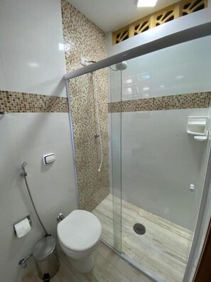 Ein modernes Badezimmer mit einer Duschkabine, einer Toilette und einem Bidet.