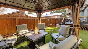 An outdoor patio with a fire pit, seating, and a covered area. - < 1 Mi to Bear Mtn! Family Ski Cabin w/ Game Room (Big Bear Lake)