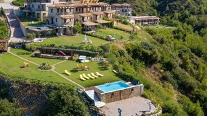 A hillside villa with multiple buildings, a swimming pool, and a well-maintained garden. - Koumaros Villas (Kassandra)