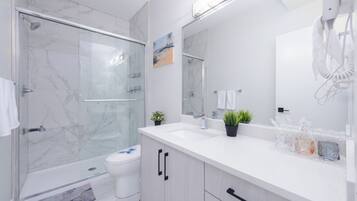 Shower, hair dryer, towels, soap