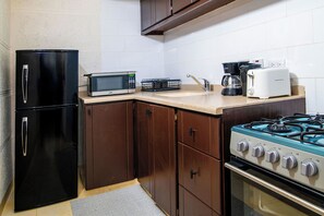 Studio, 1 King Bed | Private kitchen | Full-size fridge, microwave, toaster, cookware/dishes/utensils - Carambola Boutique Studios (St. Lawrence Gap)