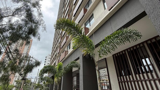 Un bâtiment moderne à plusieurs étages, doté de grandes fenêtres et de balcons.