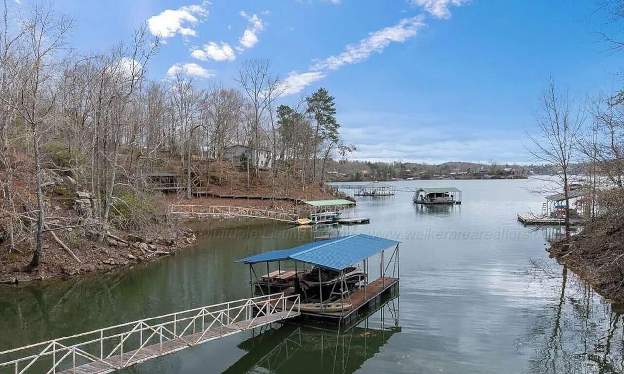 A river with boats, a dock, and a bridge.