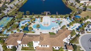 An aerial view of a residential area with a large swimming pool, tennis courts, and a fountain. - 2406 - Great Family Home Near Disney, Pool. (Kissimmee)