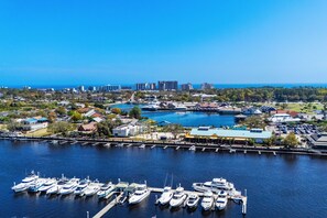 A marina with multiple boats docked, a clear view of the surrounding cityscape, and a calm water body. - Oceanfront 3-bedroom end unit in sought after Windy Hill Beach (North Myrtle Beach)