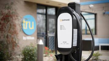 An electric vehicle charging station with a label indicating 'ENPHASE' and 'HCS-60' model.