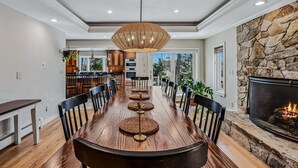A spacious dining area with a long wooden table, woven placemats, and black chairs. - Retreat w/ Southern Views | Hot Tub | Club Access (Hartford)