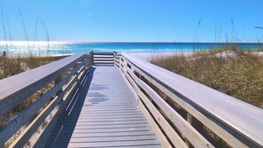 A wooden boardwalk leading to a beach with clear skies. - Sunset Balcony + 2 King Suites + Beach Gear (Fort Walton Beach)