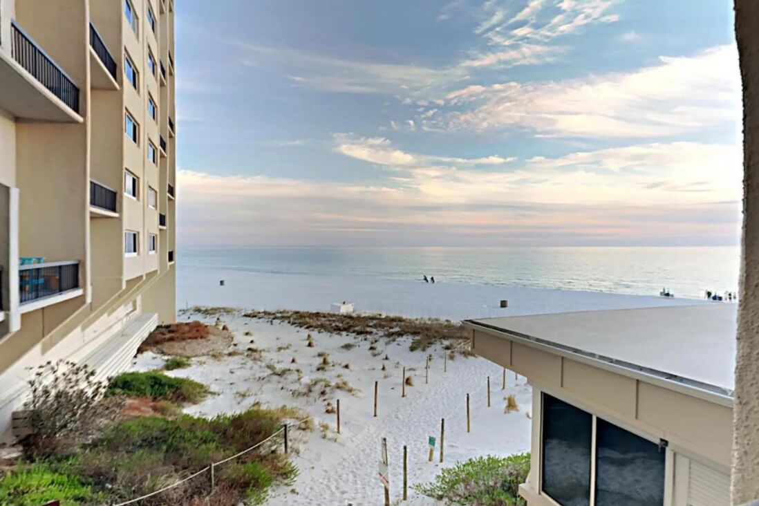 A view of a beach with a building in the foreground.