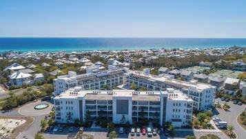 A modern hotel with a central courtyard, surrounded by a coastal residential area.