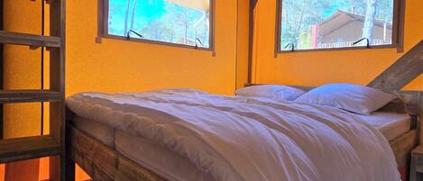 The master bedroom boasts a comfortable double bed, abundant natural light, and a serene ambiance for restful nights.