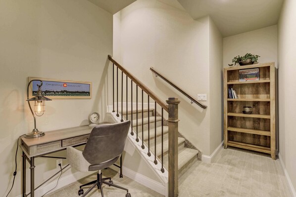 A home office with a desk, chair, and a bookshelf. - Westland Ridge! Modern Home in Historic Westside (Colorado Springs)