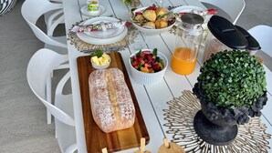A dining table set with various dishes, a loaf of bread, and decorative items.