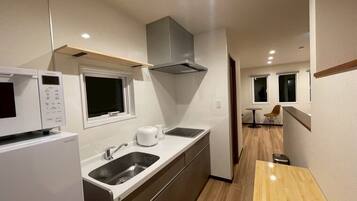 Deluxe Apartment, Garden View | Private kitchen | Fridge, microwave, stovetop, cookware/dishes/utensils