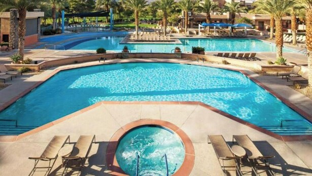 A large outdoor swimming pool with multiple lanes, surrounded by palm trees and lounge chairs. - Marriott Shadow Ridge Resort. 2 BR 2 BA Villa. Great Spring Break vacation spot! (Palm Desert)