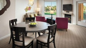 A hotel room with a round dining table, four chairs, a sofa, a TV, and a fireplace. - Marriott Shadow Ridge Resort. 2 BR 2 BA Villa. Great Spring Break vacation spot! (Palm Desert)