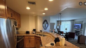 A modern kitchen with granite countertops, stainless steel appliances, and wooden cabinets. - Marriott Shadow Ridge Resort. 2 BR 2 BA Villa. Great Spring Break vacation spot! (Palm Desert)