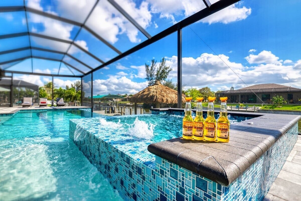 A pool with clear blue water, a tiled edge, and four Corona Light bottles on a ledge.