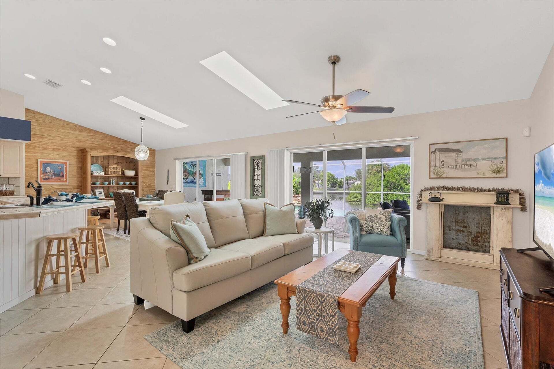 A spacious living area with a sofa, coffee table, and a fireplace.