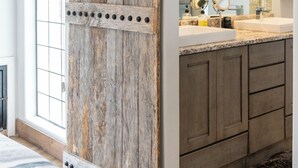 A kitchen with a rustic wooden sliding door, a built-in island with a sink, and pendant lighting. - Sedona Cowboy Retreat, Hot Tub, Game Room, Saloon (Sedona)